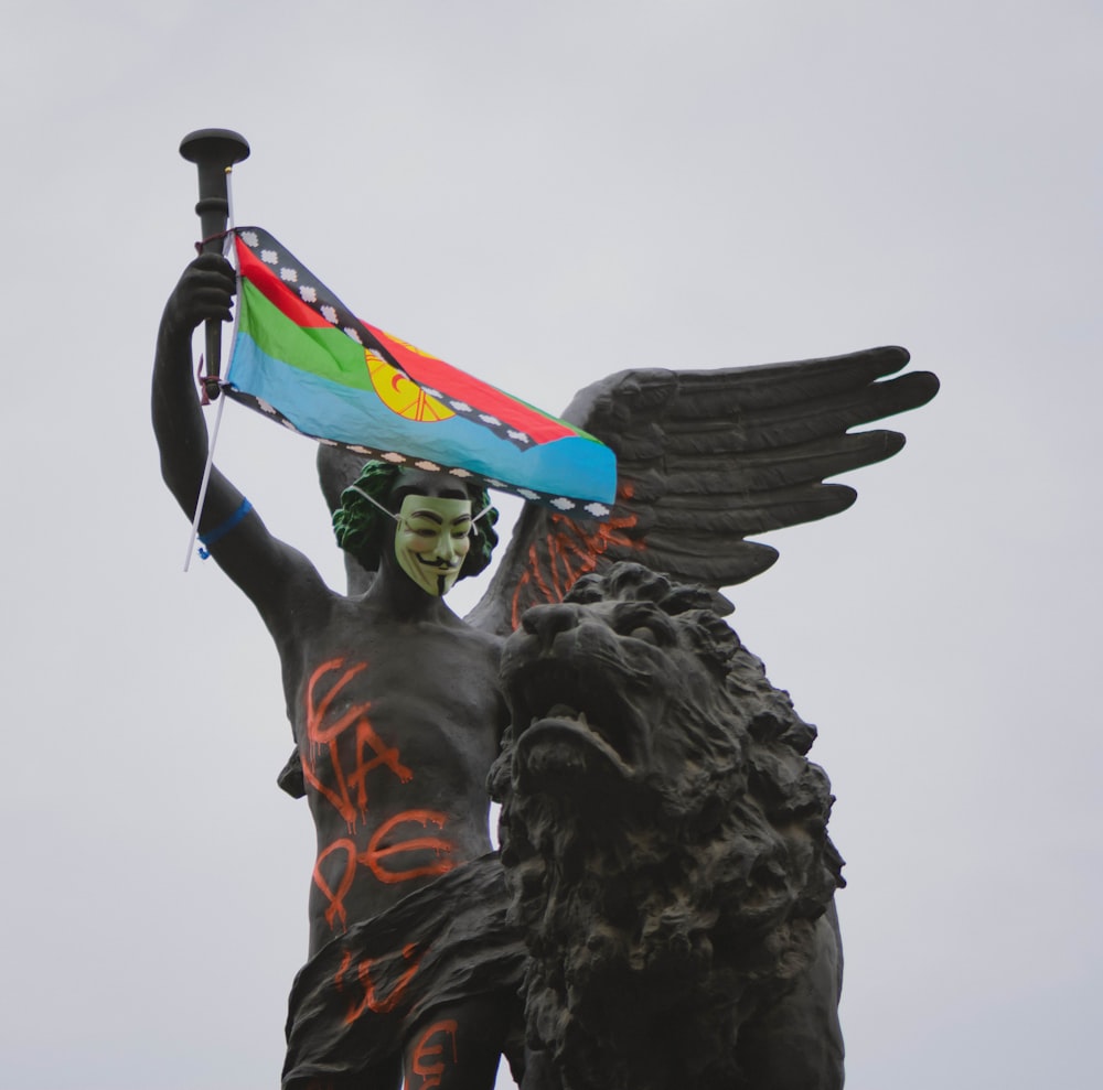 black statue with flag on top