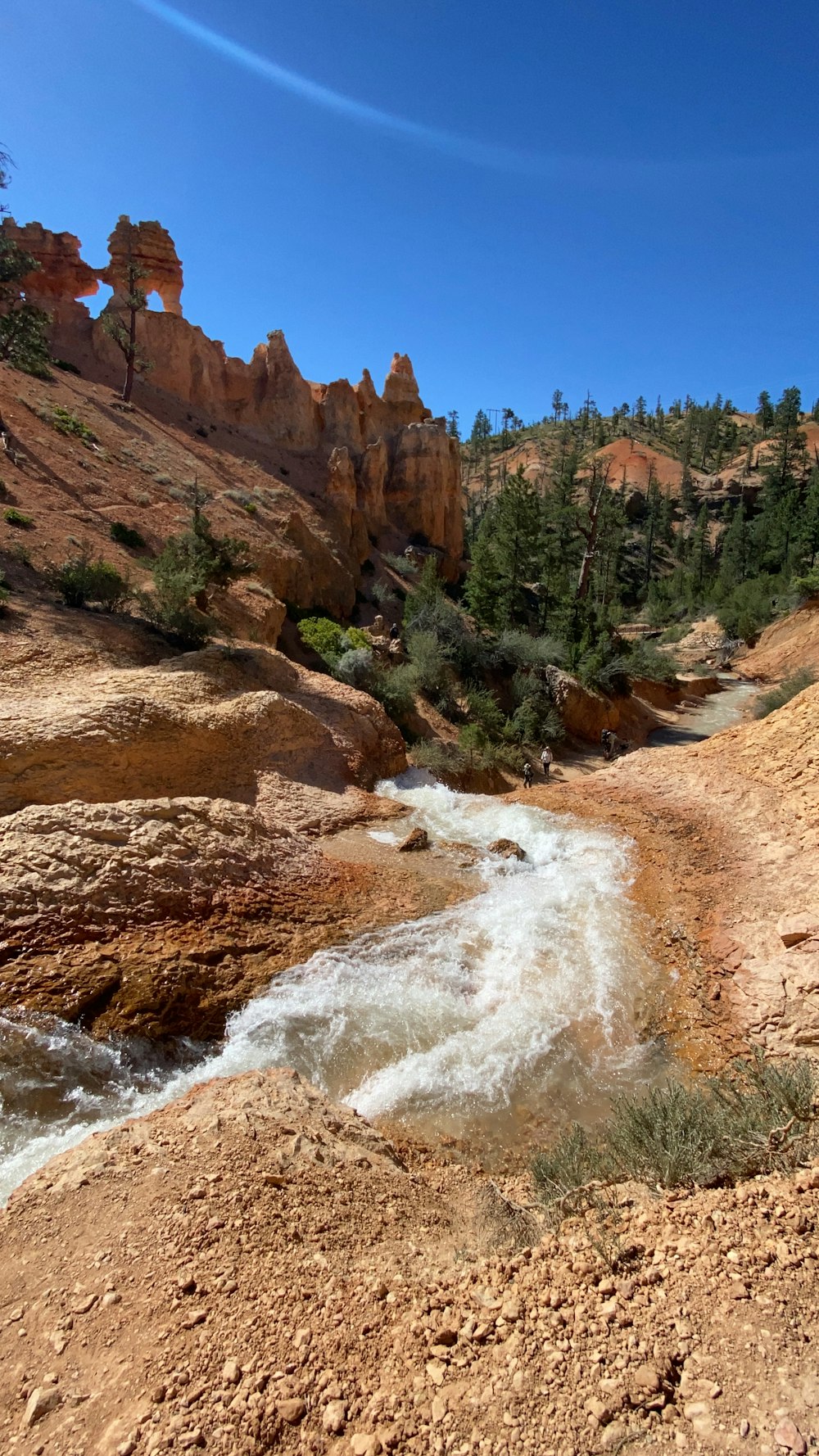 brown rocky mountain near body of water during daytime