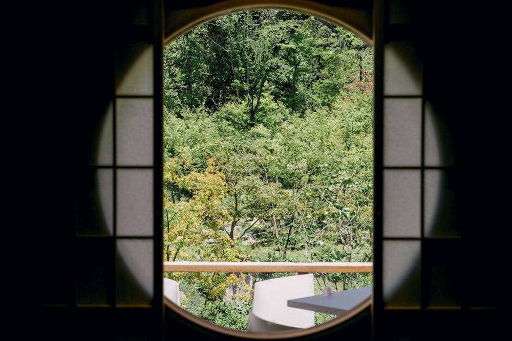 green trees near brown wooden framed glass window