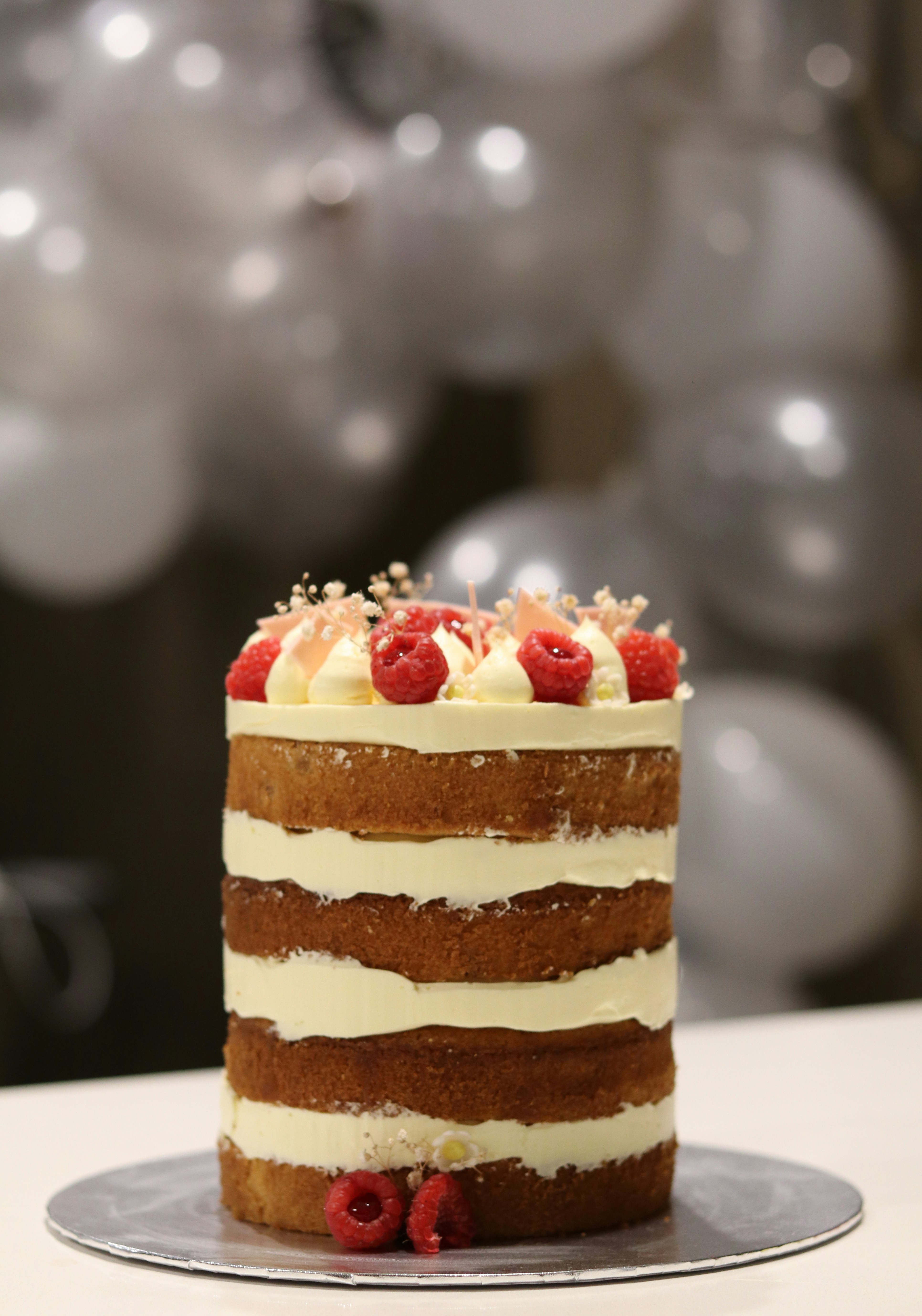 brown and white cake with strawberry on top