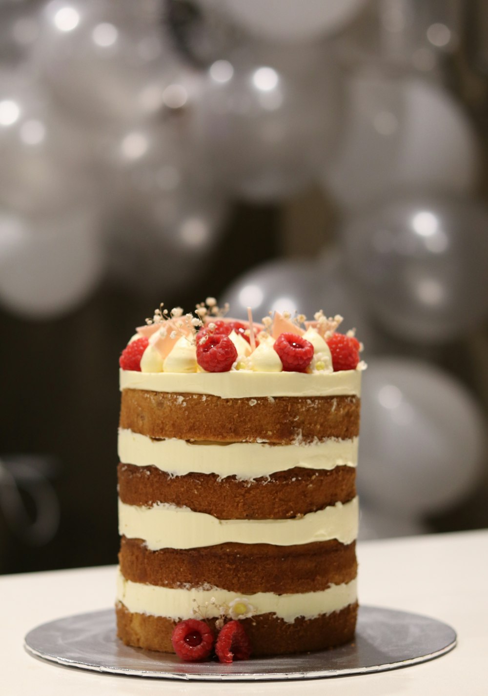 brown and white cake with strawberry on top