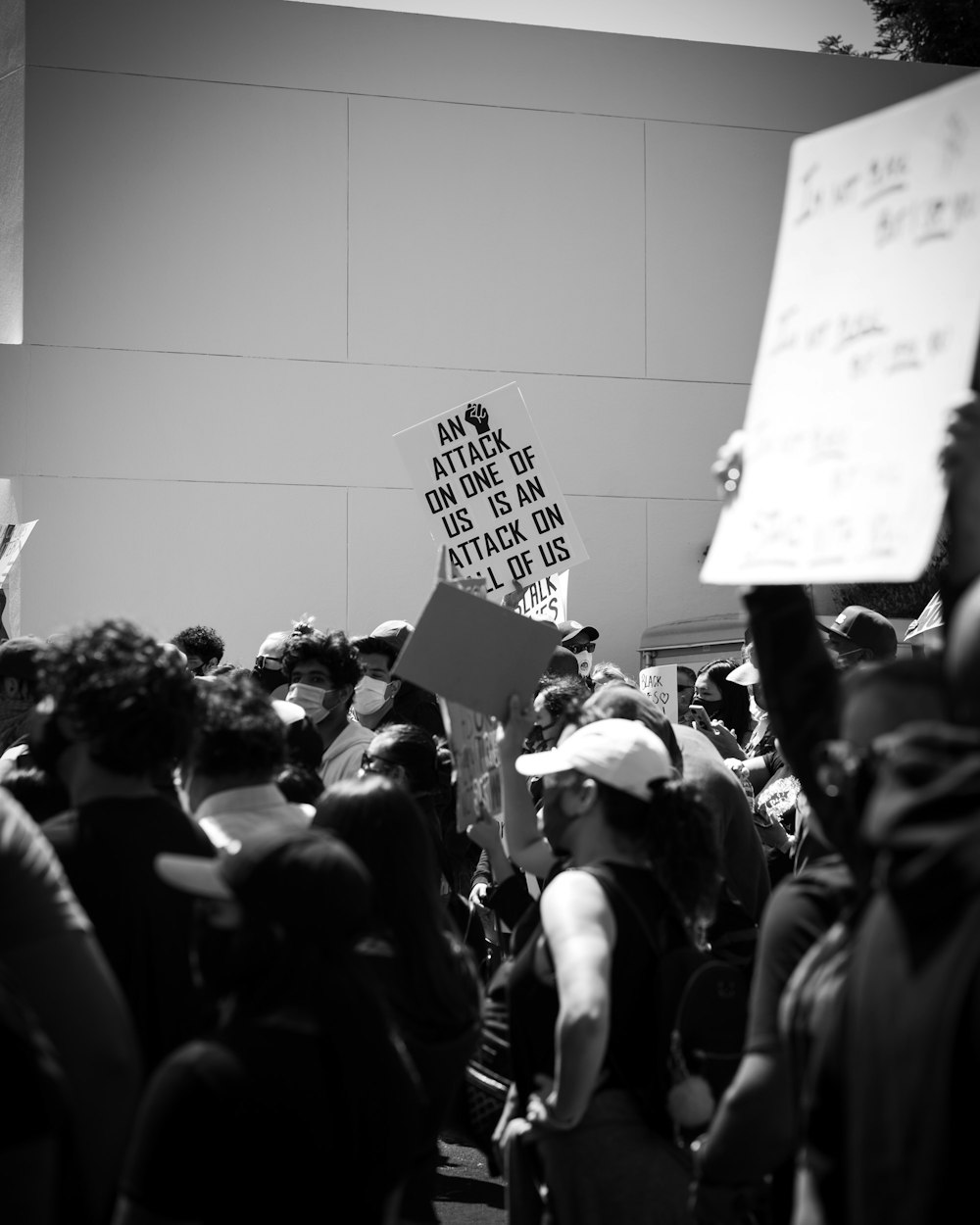 grayscale photo of people holding white printer paper