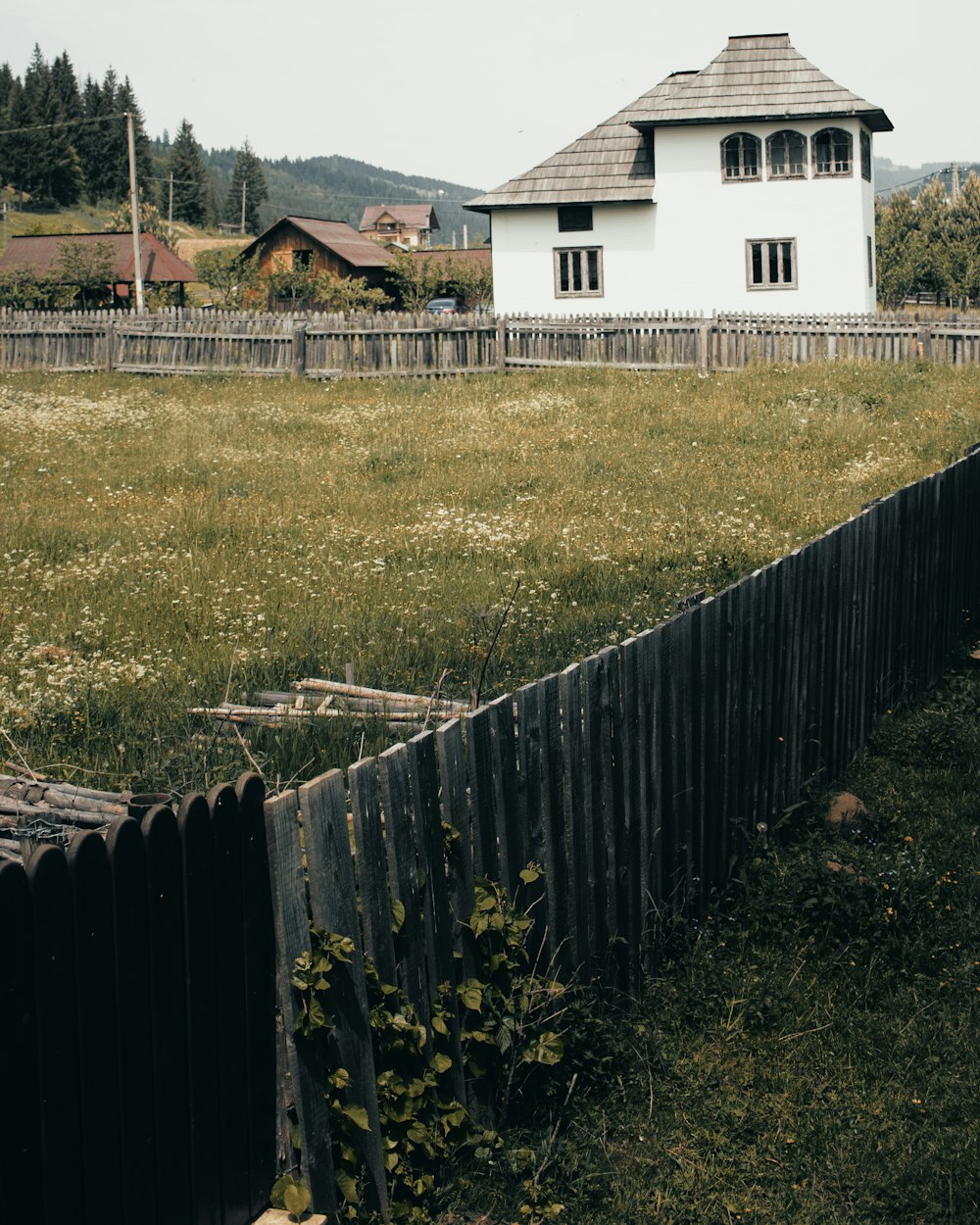 white and brown wooden fence on green grass field