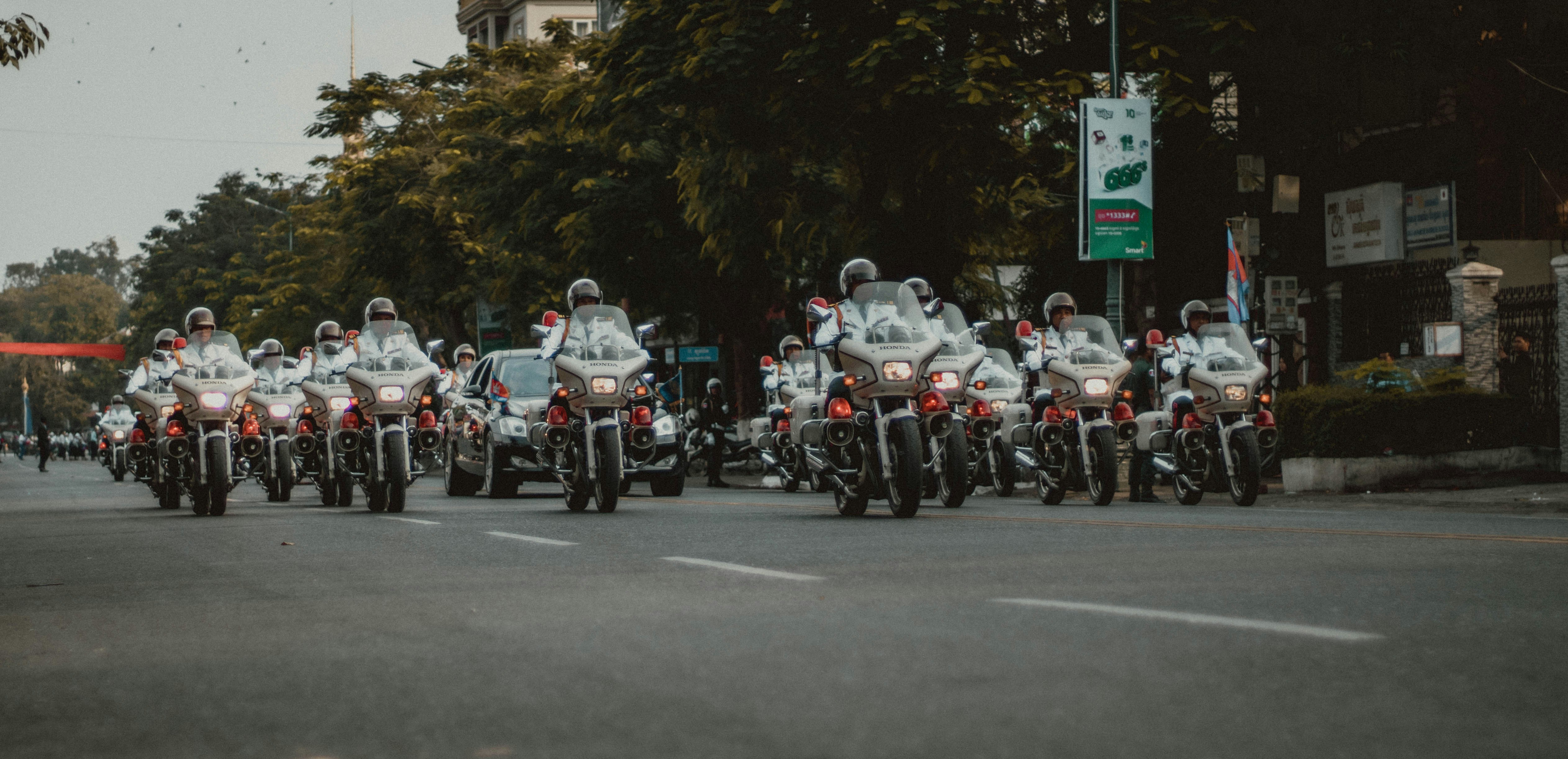 people riding motorcycle on road during daytime