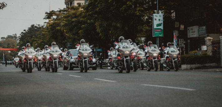 people riding motorcycle on road during daytime