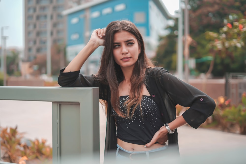 woman in black long sleeve shirt and white pants