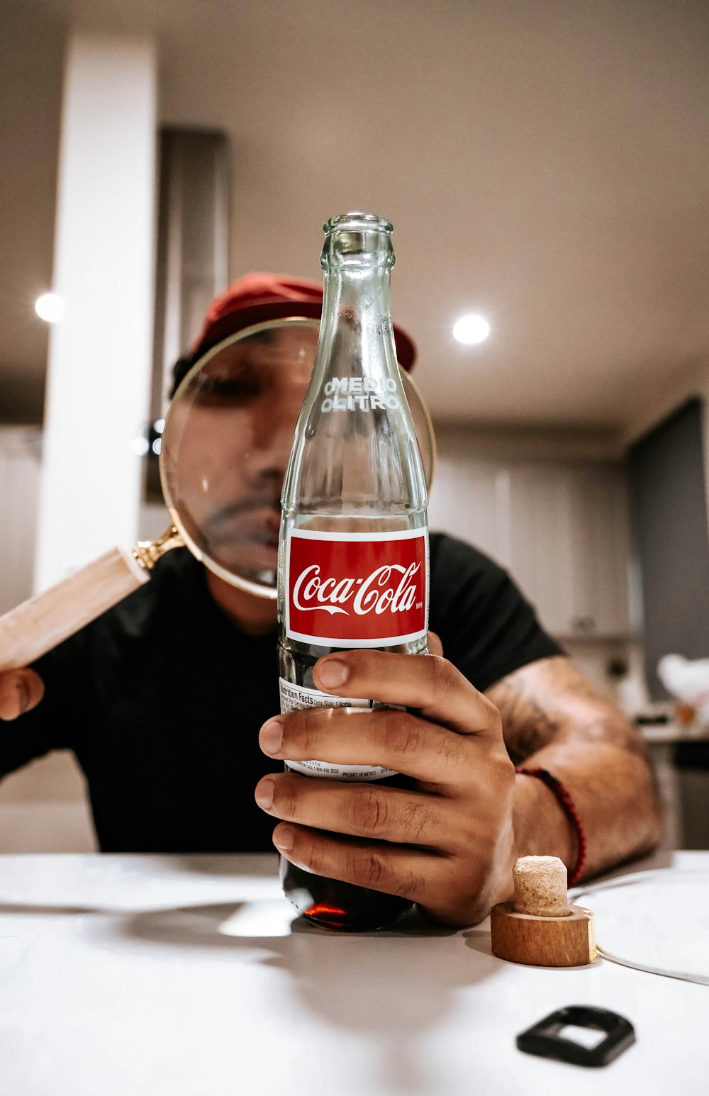 person holding coca cola glass bottle