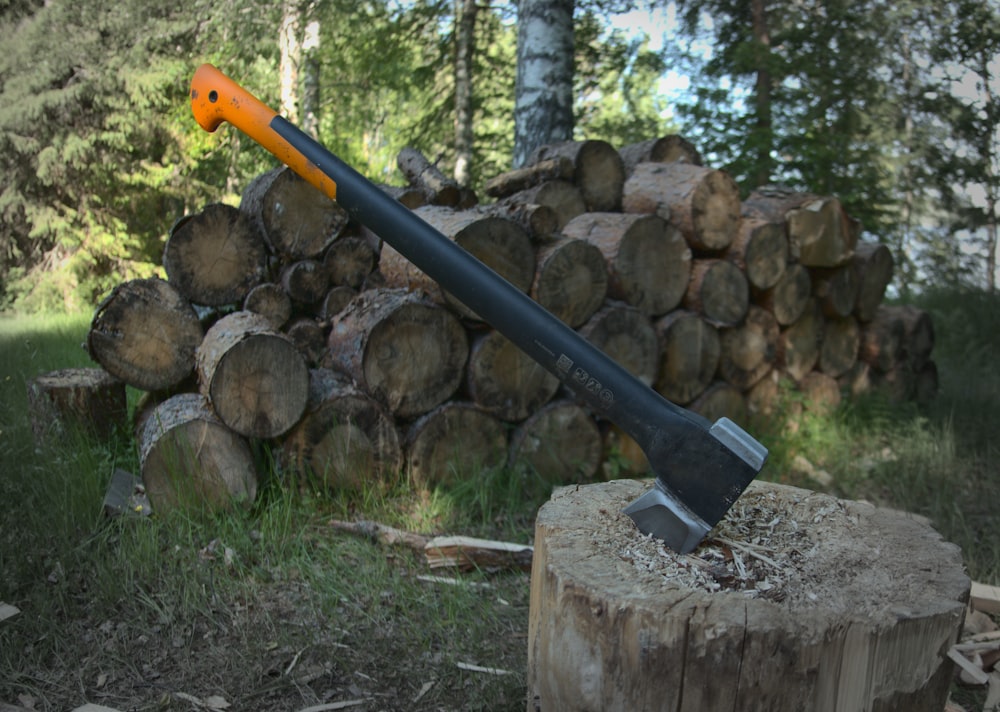 red and black axe on brown wood log