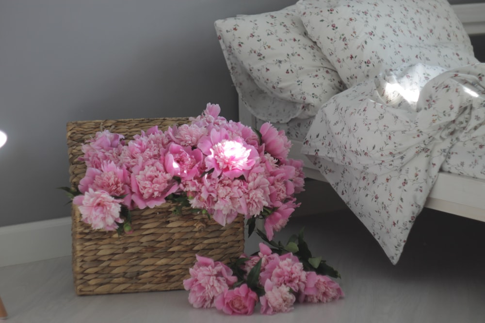 pink flowers on brown woven basket