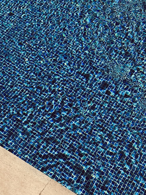 Close-up of elegant quartz finish on pool walls with upgraded tile accents
