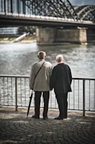 man in gray suit standing near body of water during daytime