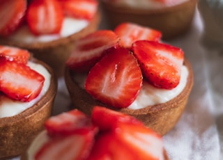 sliced strawberries on brown wooden chopping board