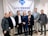 A group of seven individuals is standing in front of a banner with the ACM SIGCHI logo and text. They are dressed in business or casual attire, with varied expressions on their faces.