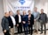 A group of seven individuals is standing in front of a banner with the ACM SIGCHI logo and text. They are dressed in business or casual attire, with varied expressions on their faces.