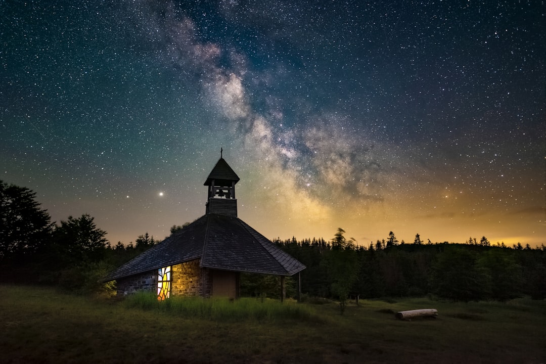 brown wooden house under starry night