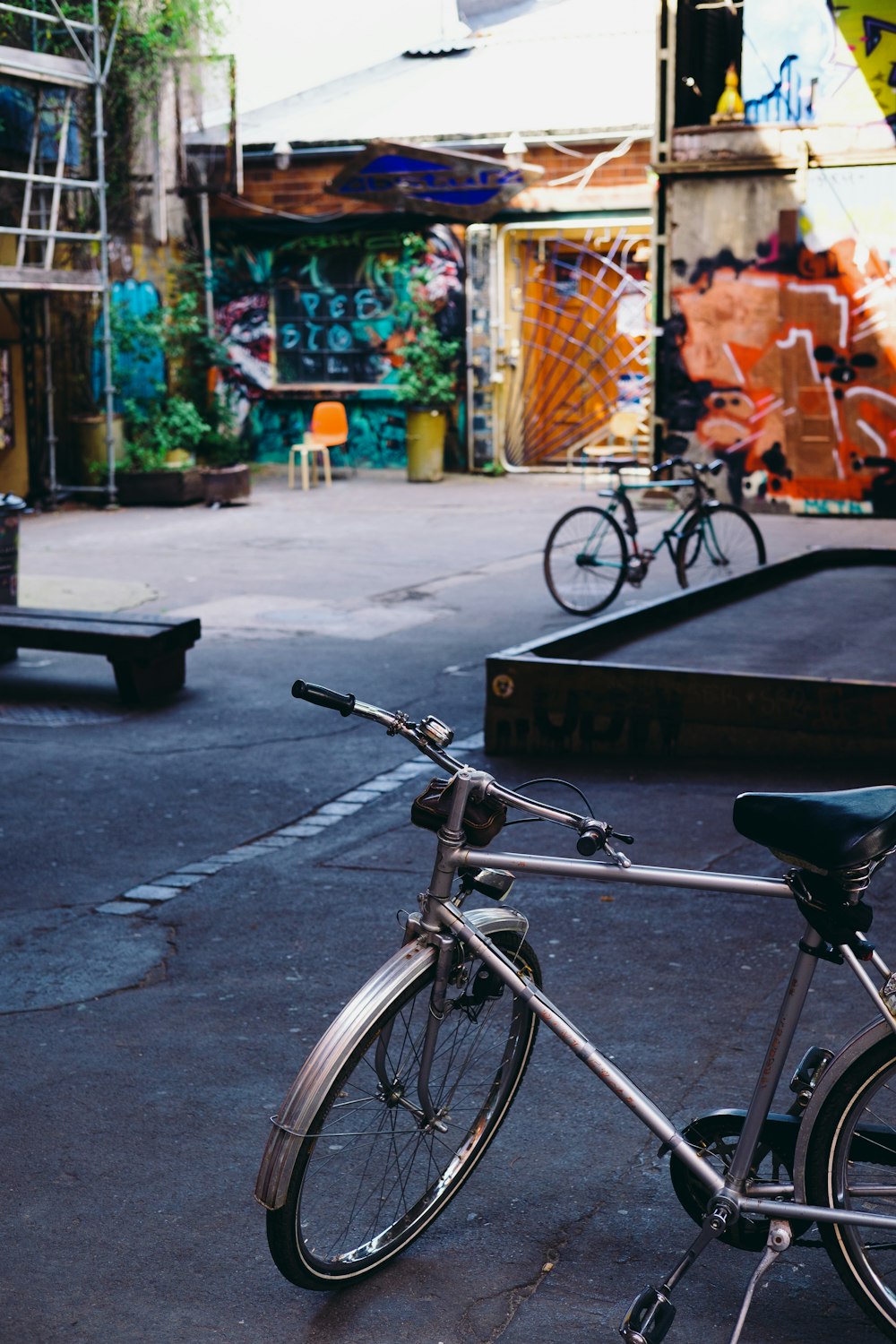 black city bike parked on sidewalk during daytime