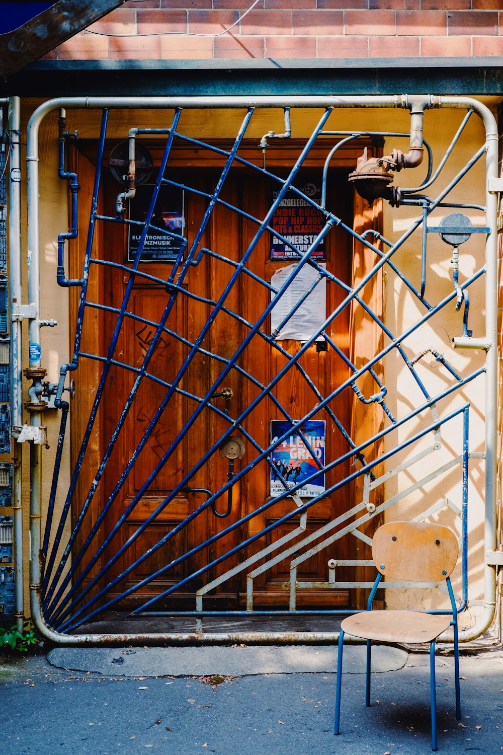 brown wooden door with blue and white graffiti