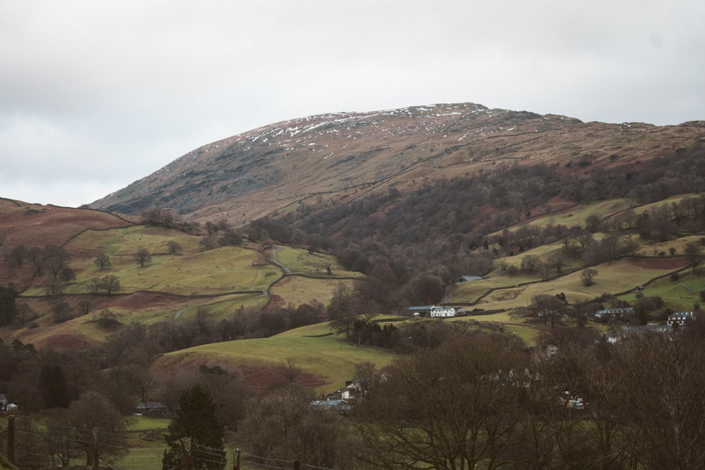 green and brown mountains under white sky during daytime