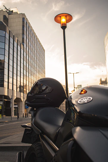 A sleek motorcycle courier navigating through a busy urban street with golden sunlight filtering in.