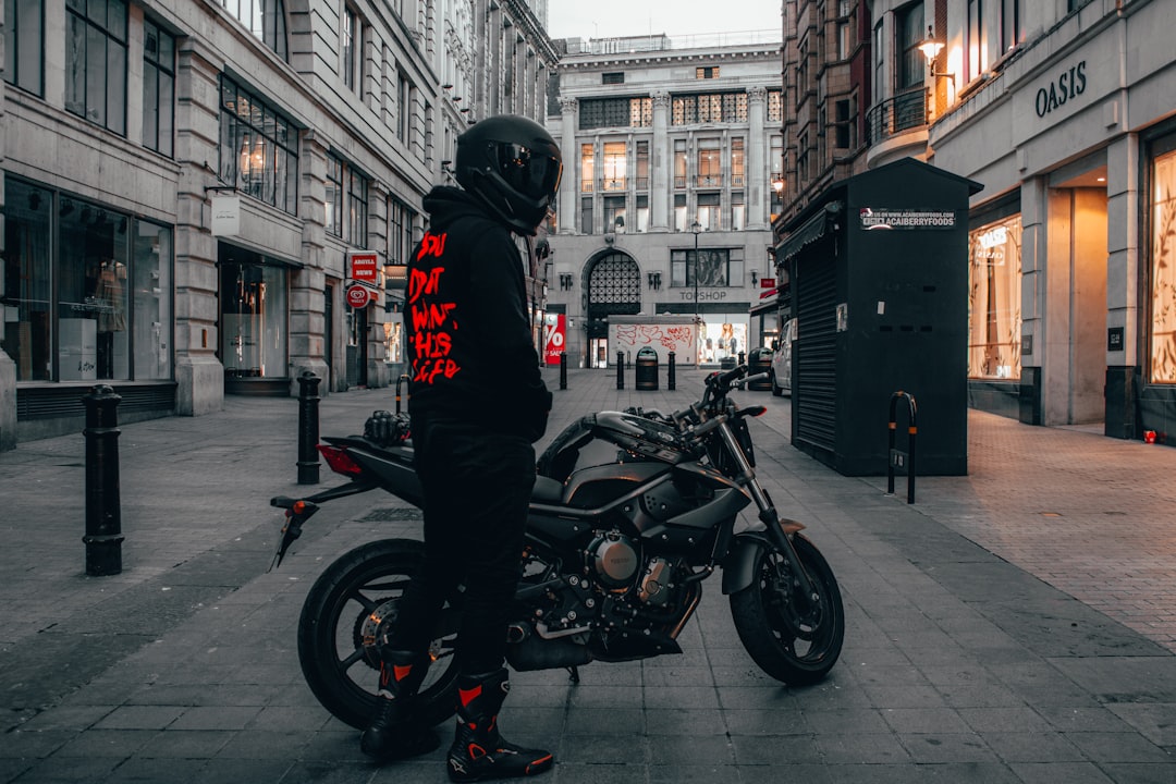 man in black jacket riding black motorcycle