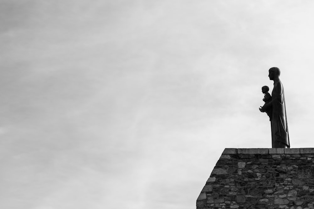 grayscale photo of concrete building under cloudy sky