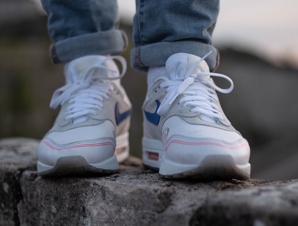 person in blue denim jeans wearing white and purple nike sneakers photo –  Free Besançon Image on Unsplash