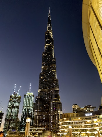 Nighttime shot of Empire World’s illuminated buildings reflecting luxury and modernity.