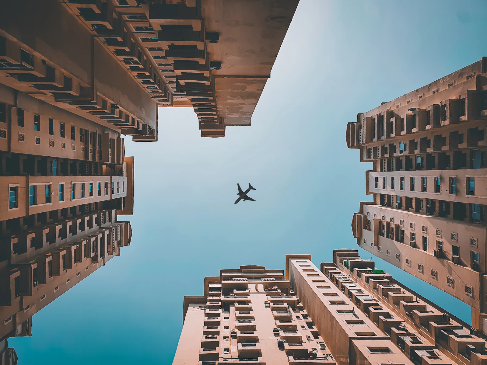 Aircraft over high-rise buildings in Noida, for PR agency in Noida