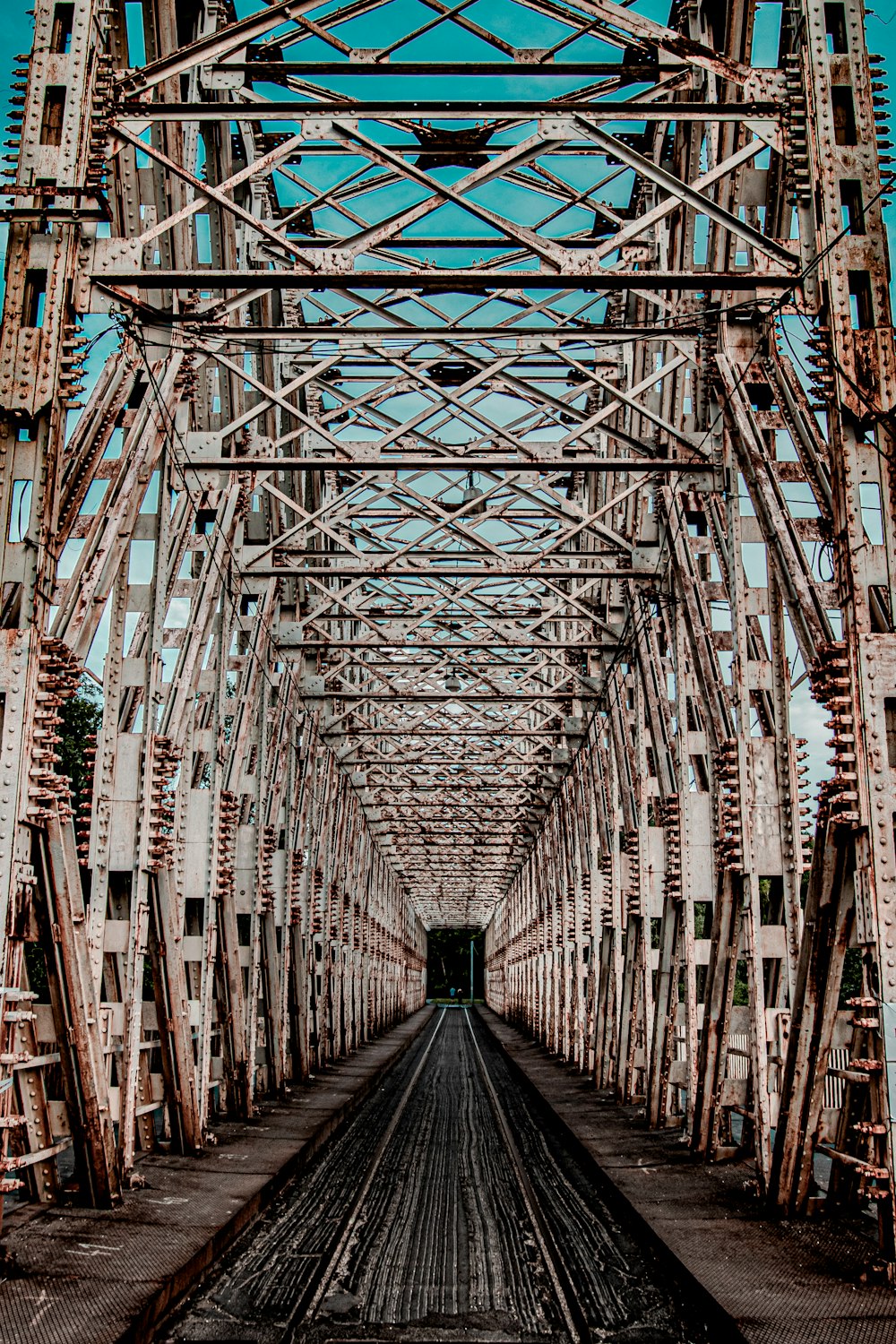 brown wooden bridge with blue and white metal frame