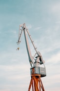 Powerful crane lifting heavy materials against a clear sky