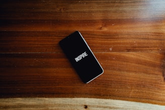 A sleek smartphone screen showing the InspireAI app interface with keyword input and tone selector.