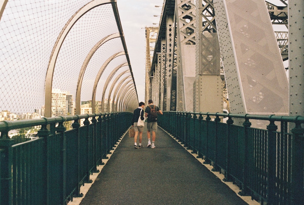 people walking on gray concrete bridge during daytime