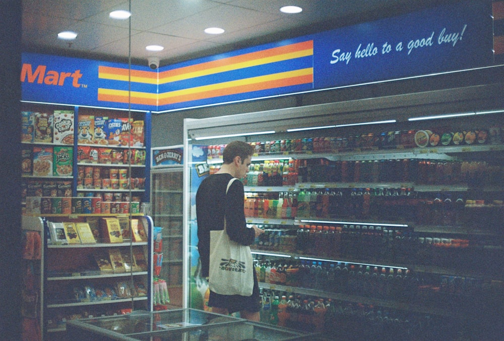 man in black shirt standing near the counter