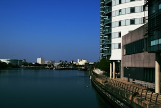 white and black concrete building beside body of water during daytime