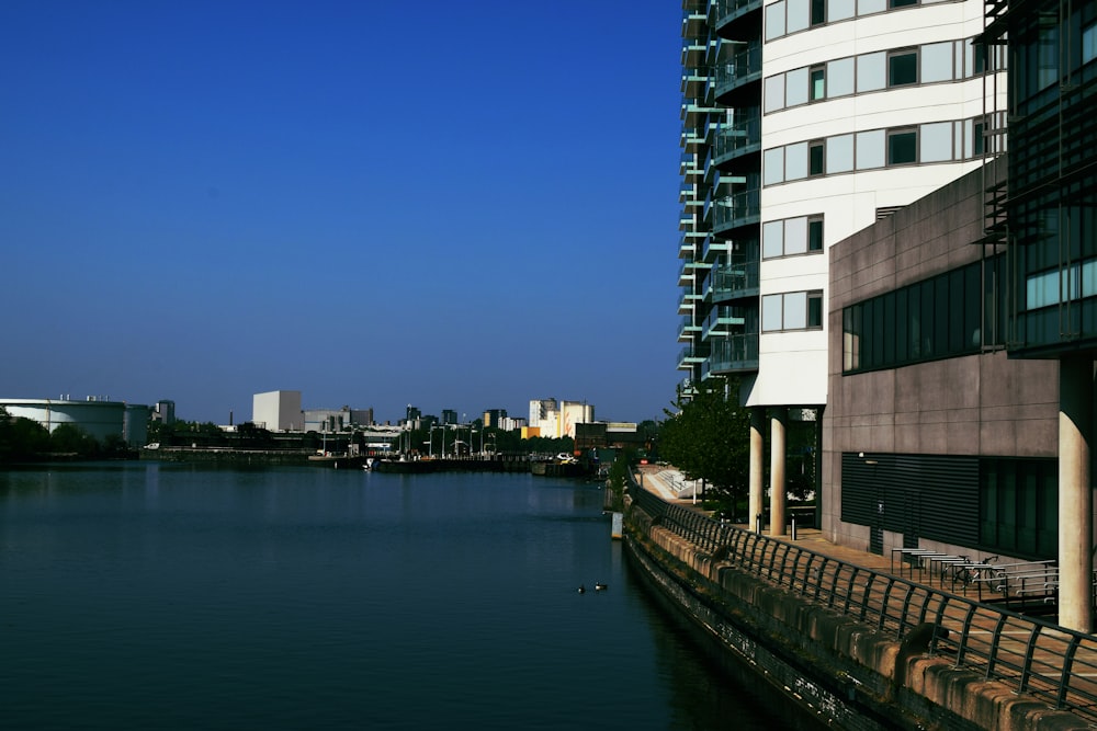 white and black concrete building beside body of water during daytime