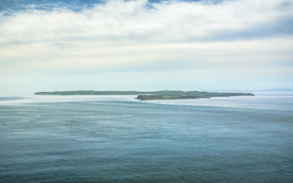 blue sea under white clouds during daytime