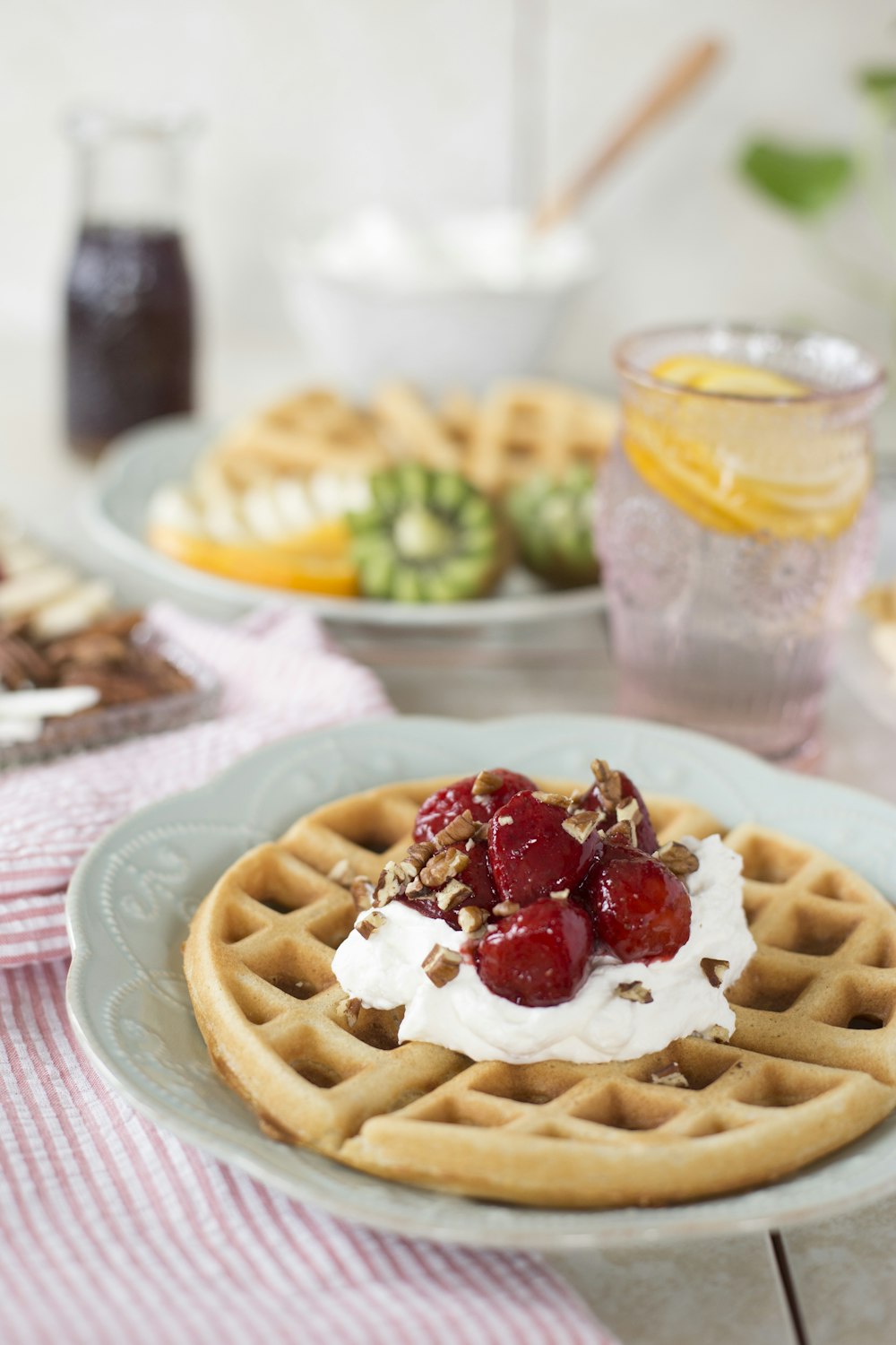 waffle with red and white cream on white ceramic plate