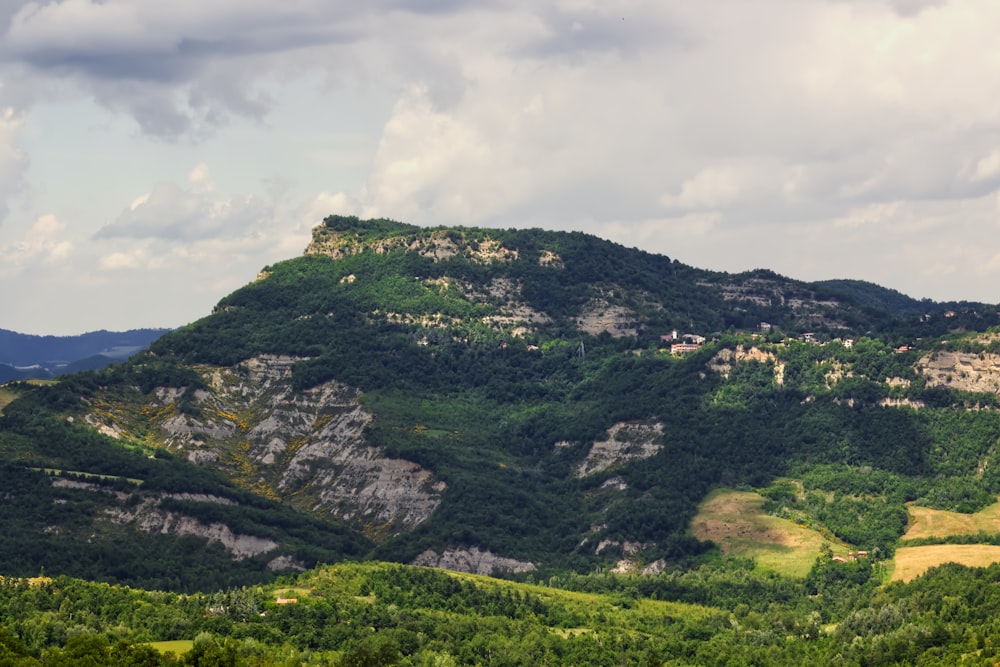 green mountain under white clouds during daytime