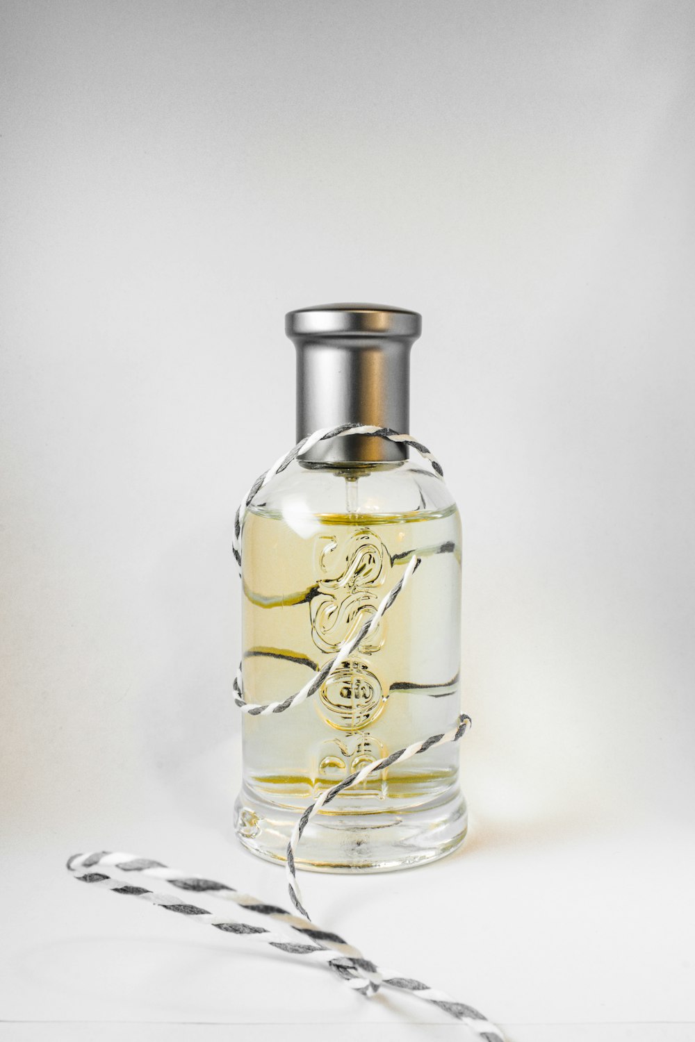 clear glass bottle with gold liquid
