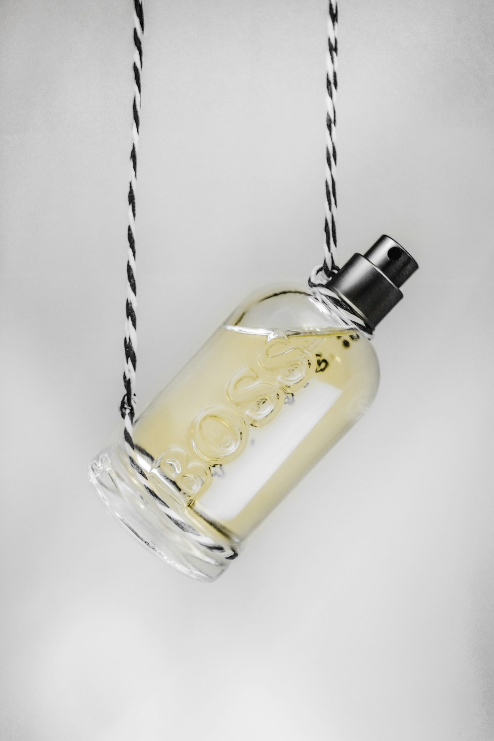 clear glass bottle with yellow liquid