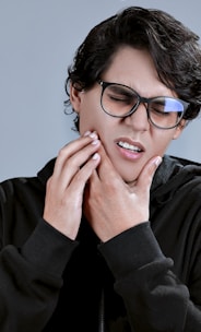 woman in black framed eyeglasses and black long sleeve shirt