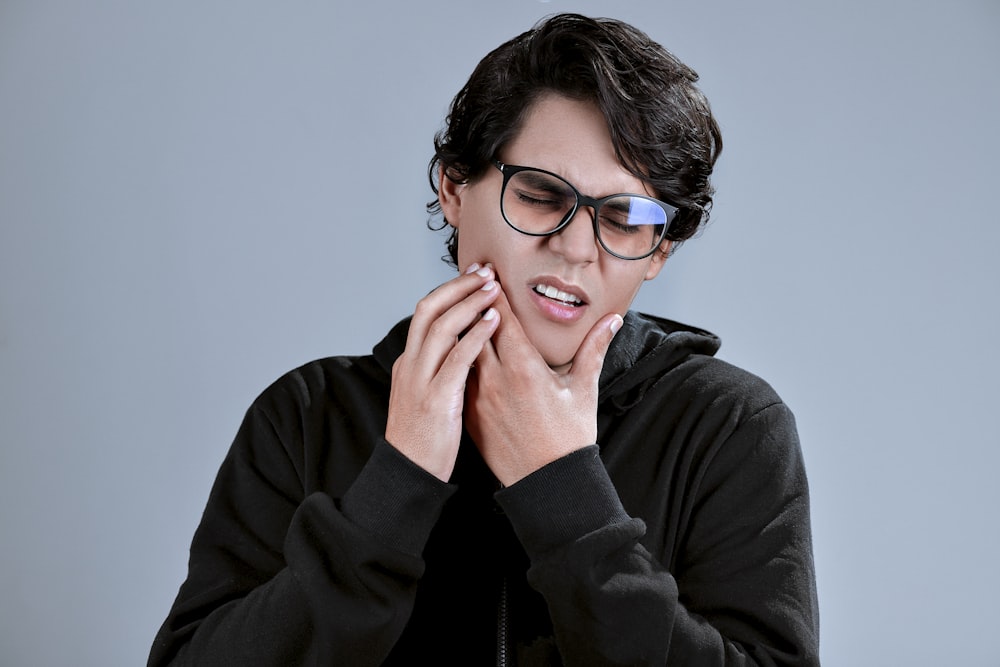 woman in black framed eyeglasses and black long sleeve shirt