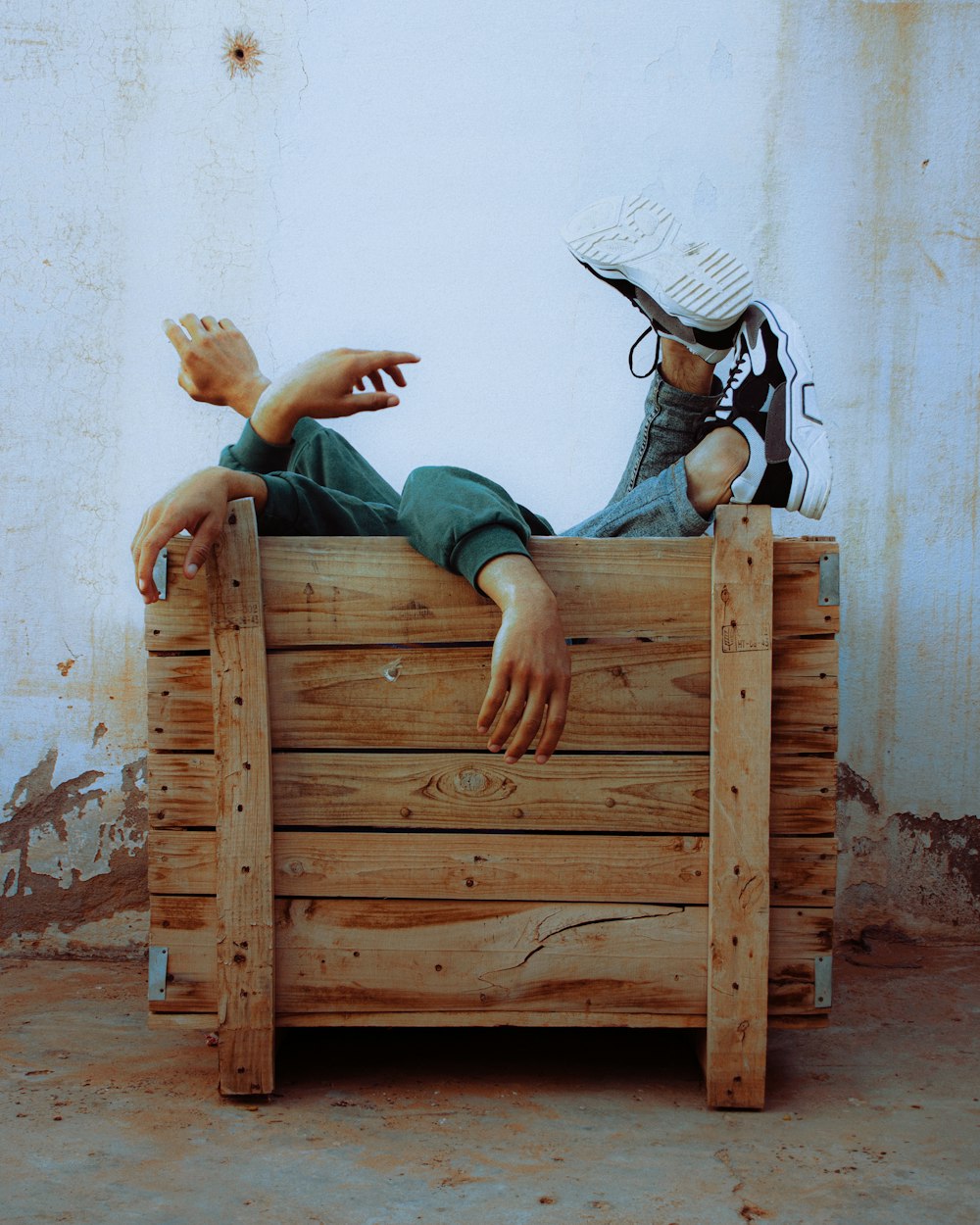 woman in blue denim jeans lying on brown wooden bed