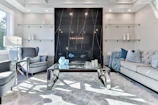 Luxurious living room featuring marble white surfaces and matte black fixtures.