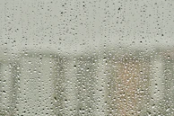Close-up of sturdy polycarbonate panels with raindrops, showcasing durability.