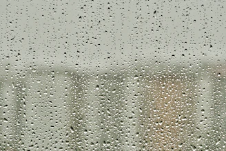 Close-up of sturdy polycarbonate panels with raindrops, showcasing durability.