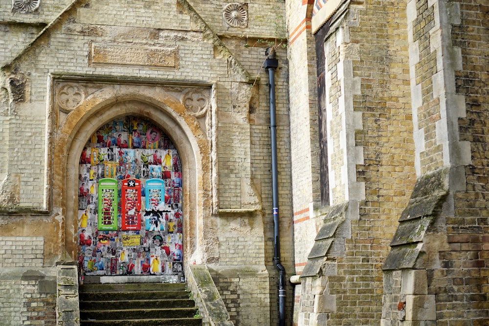 brown brick building with graffiti