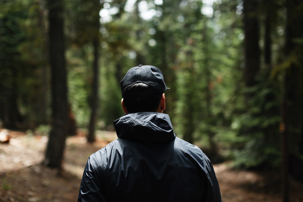 man in black hoodie wearing black knit cap