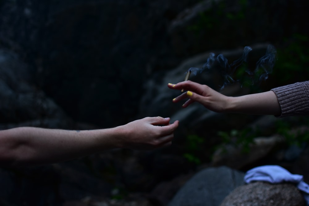 persons left hand with orange manicure