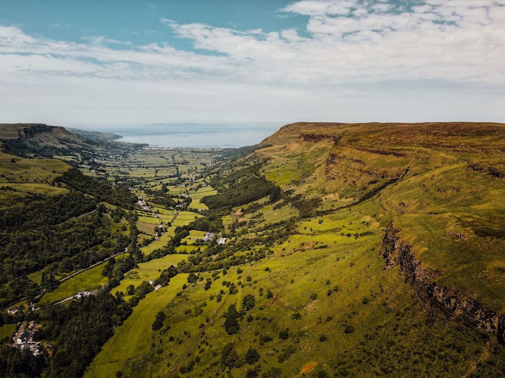 green and brown mountains under white clouds and blue sky during daytime